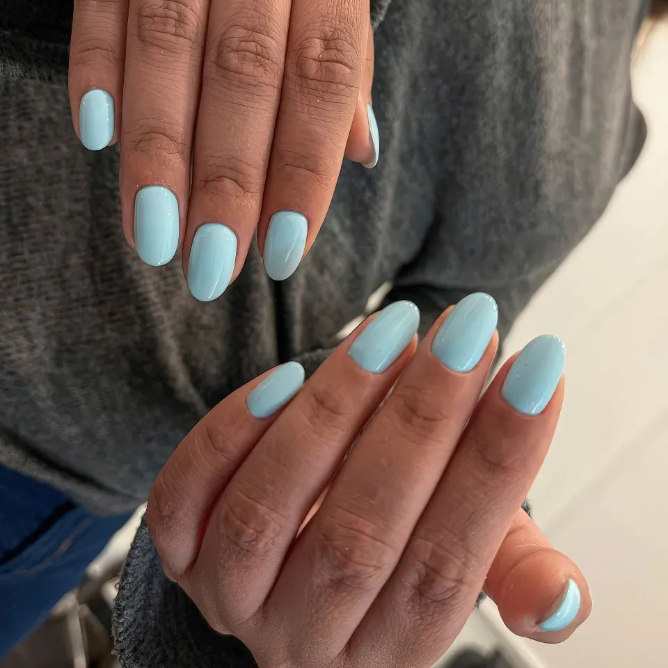 Baby blue gel polish on natural rounded nails