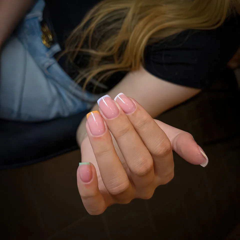 Colourful pastel micro French tips on short natural nails
