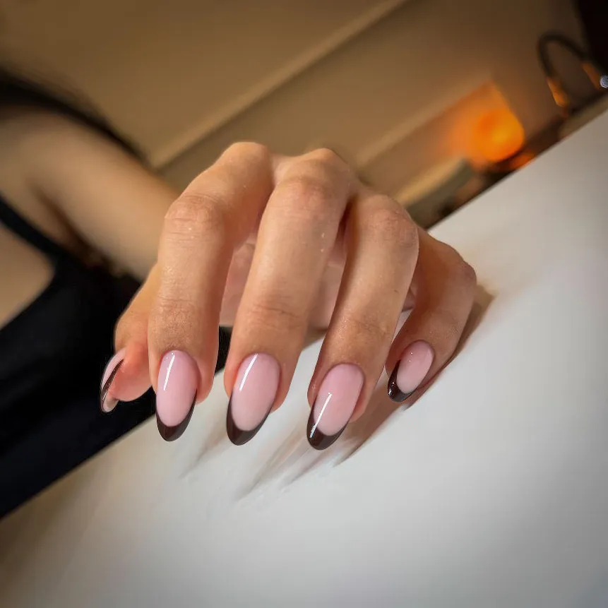 Dark chocolate French tips on almond gel nails