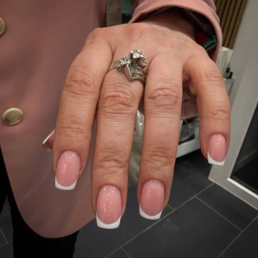 Classic white French tip manicure on square gel nails