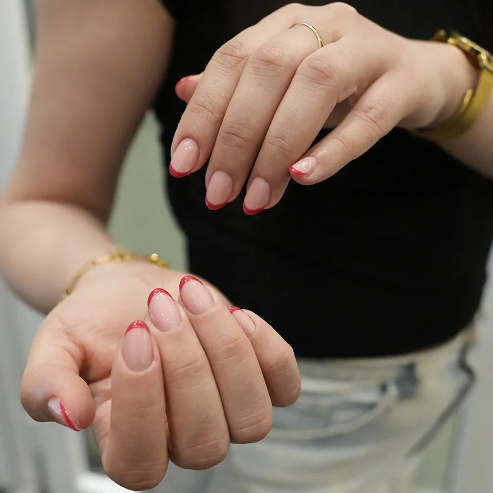 Red micro French tip manicure on natural round nails