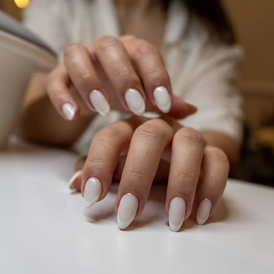 Milky white French ombré manicure on almond nails